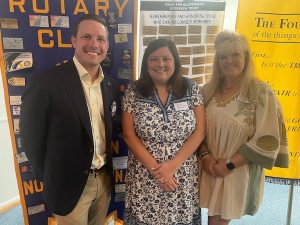 Rotarian Russell Hawkins with Becky Bennett and Allison MacDowell from Magnolia Mission