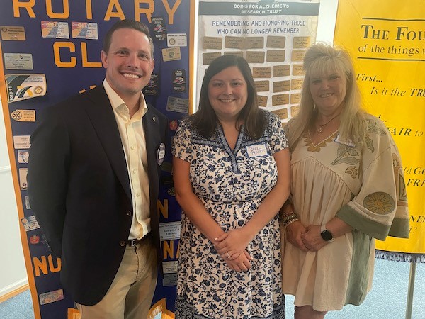 Rotarian Russell Hawkins with Becky Bennett and Allison MacDowell from Magnolia Mission